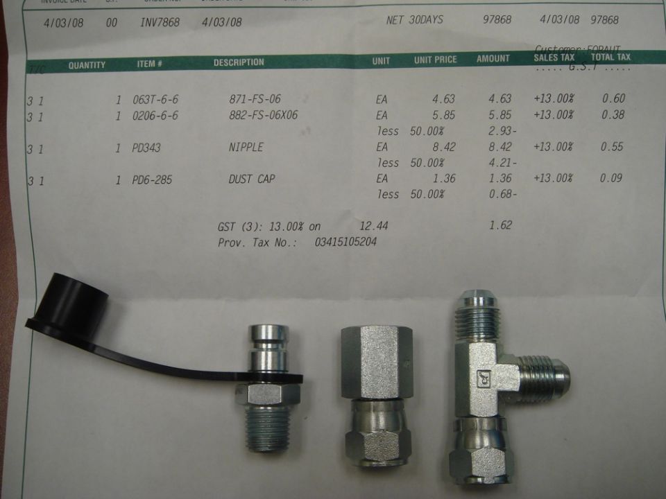 Hydraulic fittings laid on a parts invoice listing item numbers