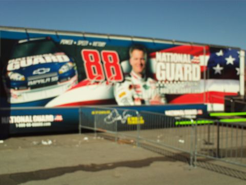 1978 Ford Bronco - A large mural on the side of a trailer features a blue Chevrolet Impala SS race car with the number 88 and a portrait of Dale Earnhardt Jr.…