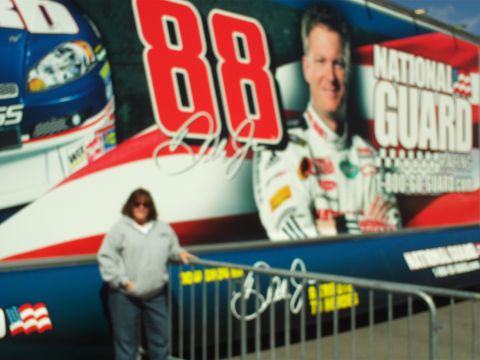 1978 Ford Bronco - A person stands in front of a large graphic featuring a race car driver and the number 88. The graphic also includes the text "NATIONAL GUA…