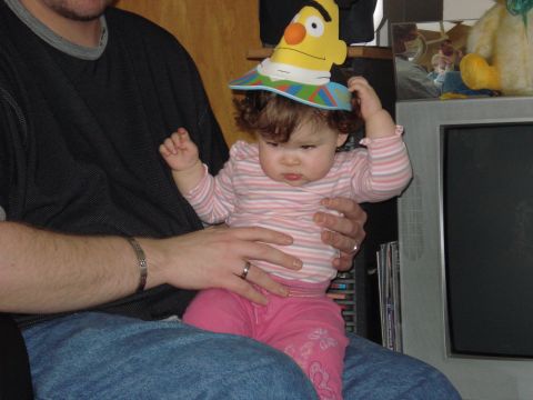 2000 Ford Crown Victoria - A baby wearing a Bert hat sits on an adult's lap.