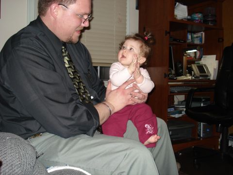 2000 Ford Crown Victoria - A man holds a baby who is clapping her hands.