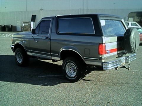 1989 Ford Bronco - This 1989 Ford Bronco is shown from the rear quarter angle, a spare tire mounted externally.