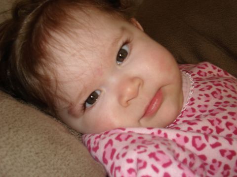 2000 Ford Crown Victoria - A close-up of a baby girl's face as she rests her head on a textured surface.