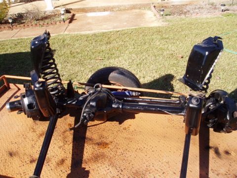 1980 Ford Bronco - Front axle assembly with suspension components is shown on a trailer.
