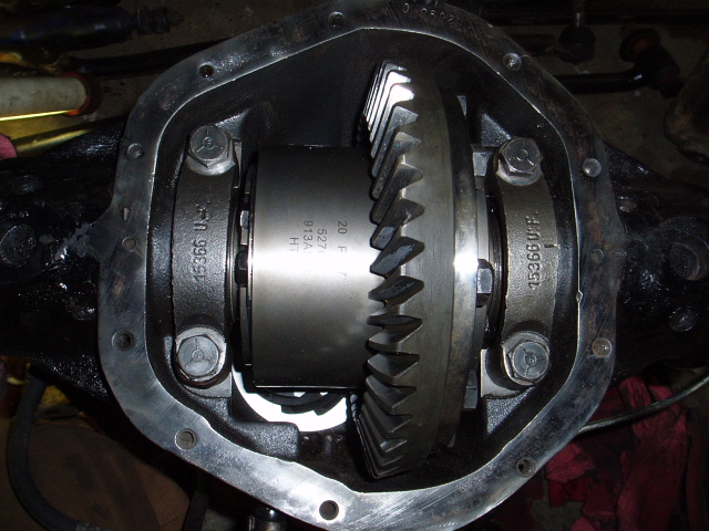 Open differential housing showing ring gear, carrier, and bearing caps with cover removed