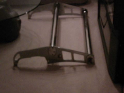 1987 Ford Bronco - A chrome automotive part is shown close-up on a surface.