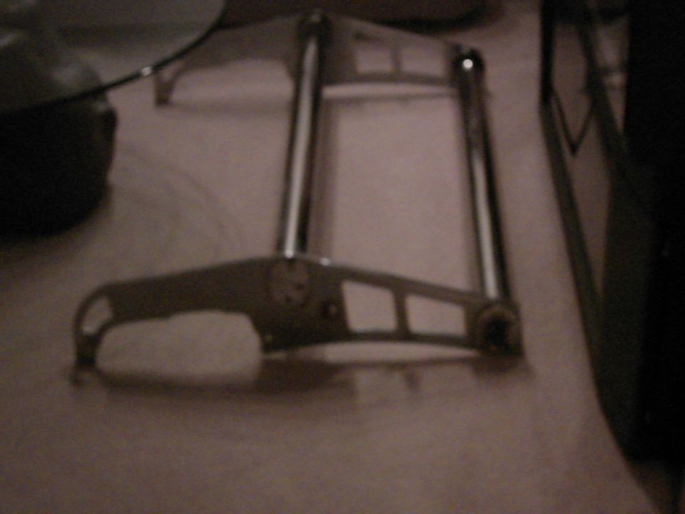 chrome part with two vertical bars and a horizontal bar