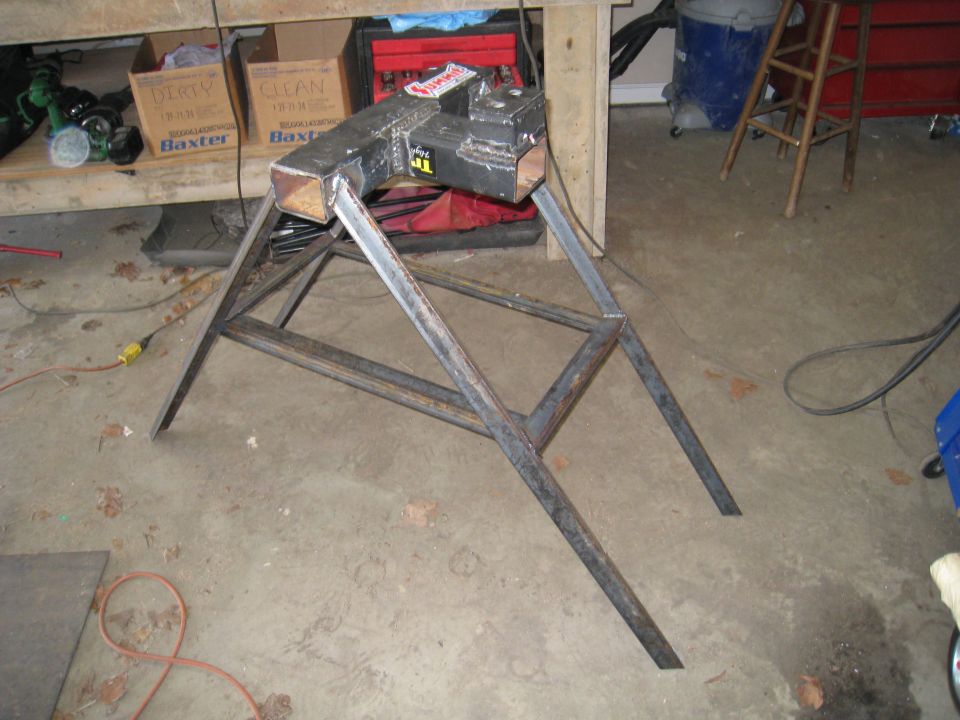 Metal vise mounted on a metal stand in a garage