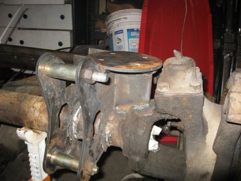 1990 Ford F-250 - Custom suspension modification on a vehicle axle, showing welded metalwork and bolts.
