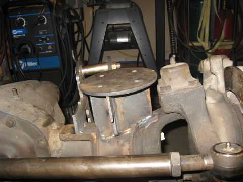 1990 Ford F-250 - Close-up of a custom suspension component, likely for an off-road vehicle, showing welded metal fabrication.