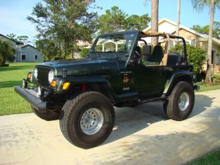1998 Jeep Wrangler - This 1998 Jeep Wrangler is shown in a 3/4 front view, parked on a paved driveway.