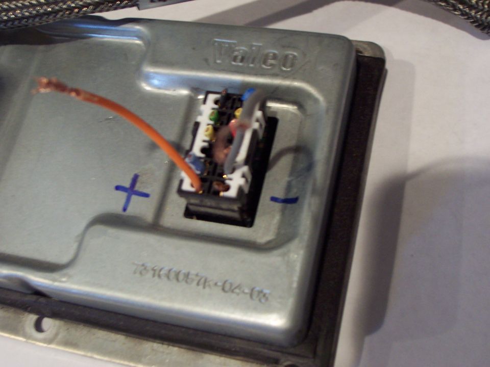 Metal automotive ballast with orange wire and electrical connector