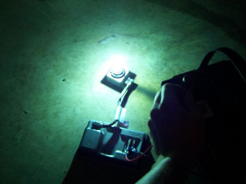 1993 Ford Probe - Hand holding a flashlight over a car battery, illuminating wires and terminals.