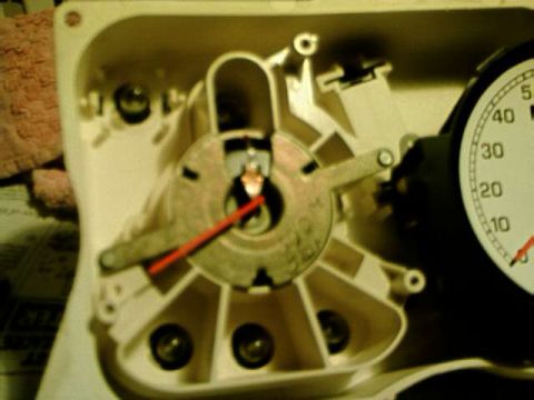 1976 Ford Ranchero - The internal workings of a vehicle's gauge cluster are shown, with a speedometer dial partially visible.