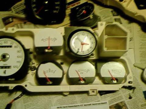 1976 Ford Ranchero - Close-up of a vehicle's dashboard gauges and clock assembly.