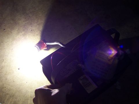 1993 Ford Probe - A hand illuminates a black box with wires and visible labels, possibly a vehicle part.