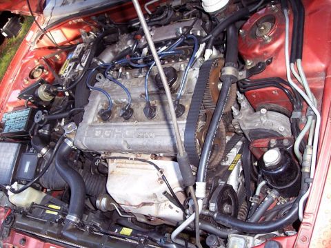 1995 Mitsubishi Eclipse - Close-up view of a car's engine bay, showing internal components and wiring.