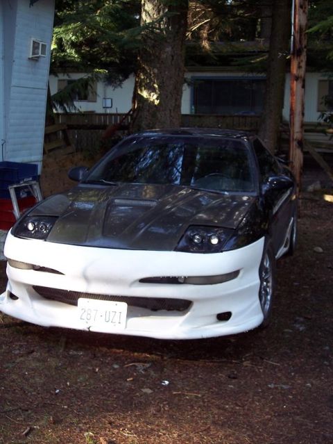 1995 Mitsubishi Eclipse - Car with custom front bumper and hood parked outdoors.