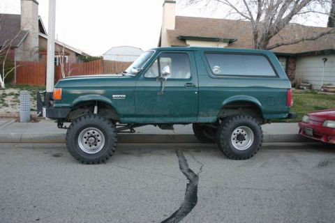 1991 Ford Bronco - This lifted 1991 Ford Bronco is parked on a residential street.
