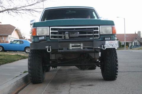 1991 Ford Bronco - This 1991 Ford Bronco features a winch and Baja decals, presented in a front-facing view.