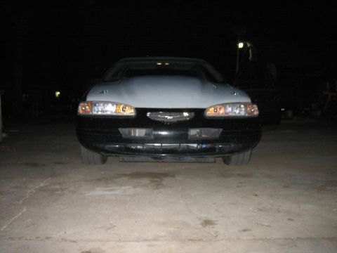 1996 Ford Thunderbird - Front view of a 1996 Ford Thunderbird, a two-tone paint scheme with a black lower body and a light-colored hood.