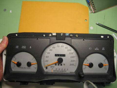 2004 Ford Crown Victoria - Instrument cluster with speedometer, fuel, and temp gauges. Odometer reads 328599.