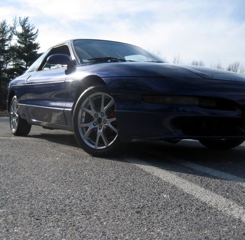 1993 Ford Probe - A dark blue 1993 Ford Probe GT is shown from the front 3/4 angle on a sunny day.