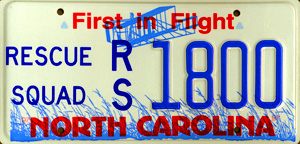 1998 Ford Crown Victoria - This North Carolina license plate displays "RESCUE SQUAD" and the number "1800" with a "First in Flight" slogan.