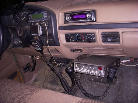 1996 Ford Bronco - The interior of a vehicle shows a CB radio, a Kenwood device, and an aftermarket stereo system installed.