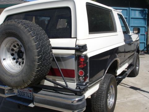 1989 Ford Bronco - This 1989 Ford Bronco features a two-tone paint scheme and a rear-mounted spare tire.