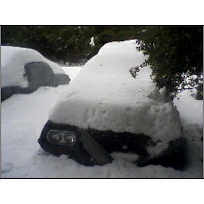 1972 Ford Ranchero - Cars are buried under a heavy blanket of snow, suggesting a harsh winter day.