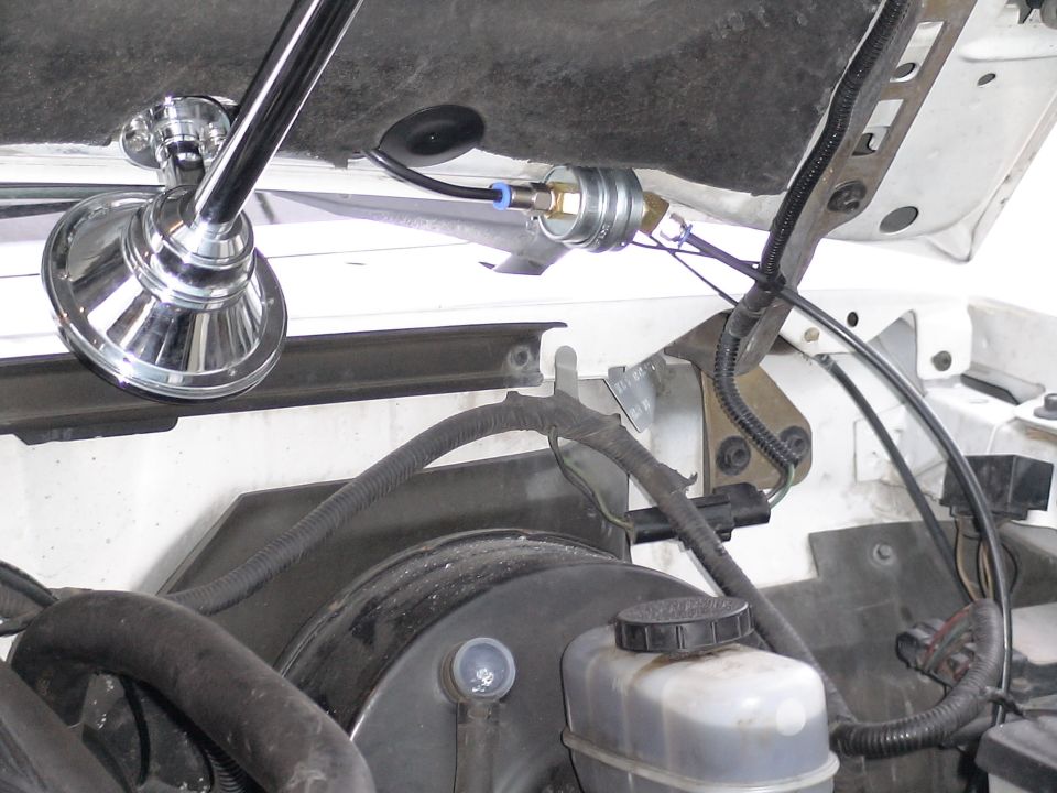 Chrome air horn and pressure switch mounted in engine bay