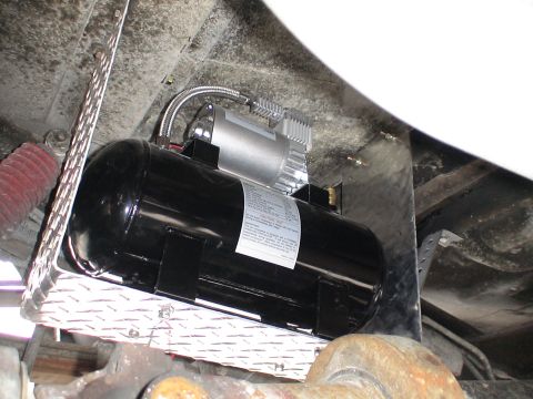 1993 Ford C-350 (Centurion Conversions) - Underside view of an air compressor and tank system, likely for air horns or suspension.