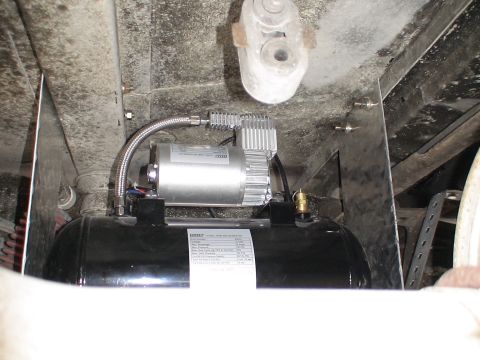 1993 Ford C-350 (Centurion Conversions) - Under-vehicle air compressor and tank assembly with visible labeling.