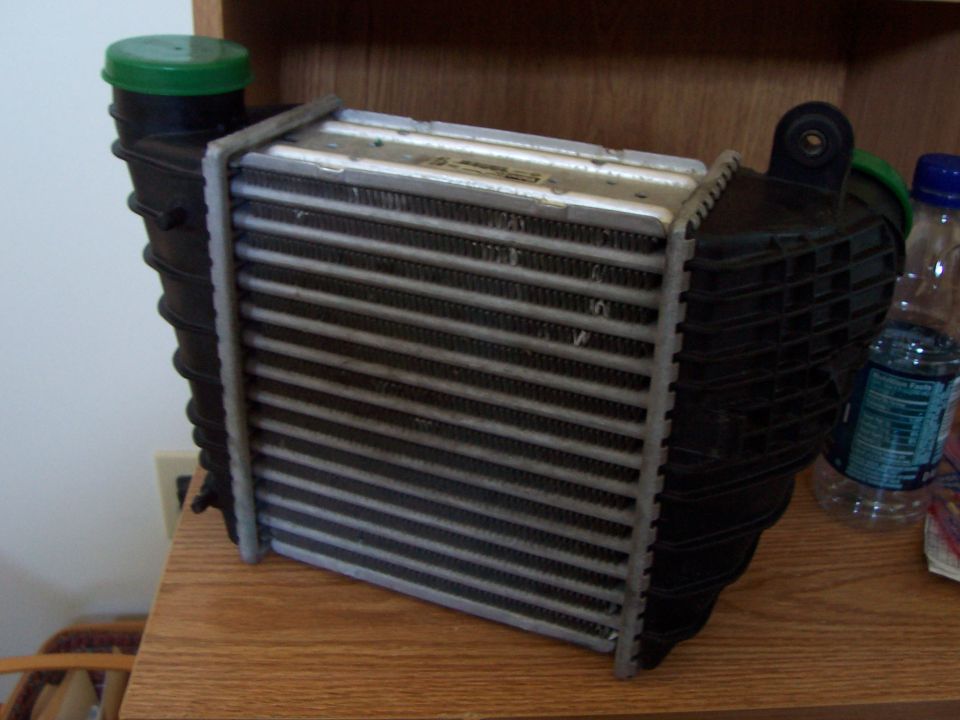 Intercooler with black plastic end tanks and a green cap