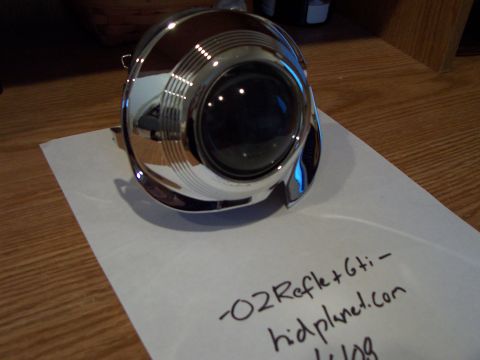 1993 Ford Probe - A chrome headlight projector unit is shown on a piece of paper with handwritten text and a SuperMotors logo.