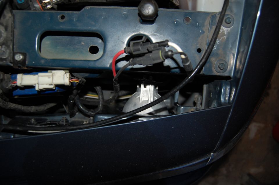 Front-end wiring harness and connectors behind dark blue bumper cover