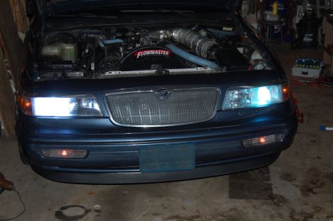 1985 Mercury Grand Marquis - Front view of a 1995 Mercury Grand Marquis with hood open, engine visible.
