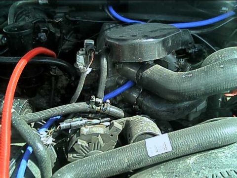 1989 Ford Bronco - Close-up view of engine bay components including hoses and alternator, with a Supermotors.net logo.