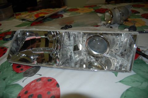 1985 Mercury Grand Marquis - A disassembled headlight assembly is shown with a projector retrofit kit.