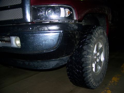 2001 Dodge 1500 - Front corner view of a 2001 Dodge 1500 pickup truck, showing its large tires and bumper.
