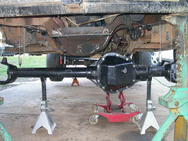 A coupe of plumb bobs hung through the center bolt hole of the coil bucket help get the axle centered up under the truck.