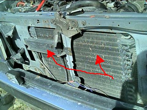 1989 Ford Bronco - Front-end view with the grille removed, looking at the radiator core support of a truck with the A/C condenser and an auxiliary cooler stac…