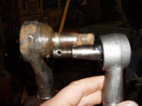 1980 Ford Bronco - Close-up of automotive steering linkage components, showing wear and replacement.