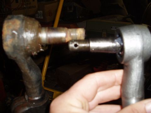1980 Ford Bronco - A rusty tie rod end is compared to a new one, likely for a vehicle repair.