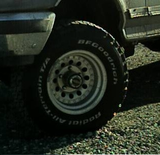 1989 Ford Bronco - Close-up of a 1989 Ford Bronco wheel and tire, showing BFGoodrich All-Terrain T/A Radial tires.