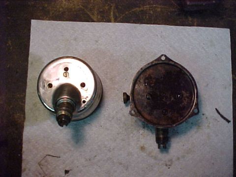 1915 Ford Model T - Two automotive gauges, one chrome and one rusted, are shown on a paper towel.