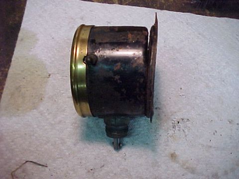 1915 Ford Model T - This is an old car headlight, likely from the early 20th century, with visible signs of age and corrosion.