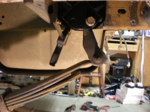1993 Ford Bronco - Underside view of a vehicle's suspension system, showing a bracket and leaf springs.