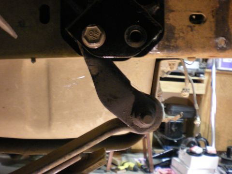 1993 Ford Bronco - A close-up view of a vehicle's suspension system, showing a bracket and leaf spring assembly.
